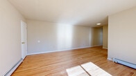 Located at 47 Madison Gardens in Old Bridge, NJ, this two-bedroom, one-bathroom single-floor home offers a clean, functional layout with consistent hardwood flooring throughout. The spacious living room is bathed in natural light streaming through a sliding glass door that opens to a private balcony with outdoor views, creating an airy and welcoming atmosphere. Baseboard heating runs through multiple rooms, ensuring consistent comfort year-round.

The kitchen is thoughtfully updated, featuring dark cabinetry with modern hardware, light quartz countertops, a subway tile backsplash, a stainless steel sink, and white appliances including a gas range and dishwasher. A window above the sink provides natural light and outdoor views.

The generously sized primary bedroom includes a walk-in closet with built-in shelving and a large window that allows ample natural light. The second bedroom is well-proportioned with neutral walls and the same warm hardwood flooring found throughout the home. A hallway connects the bedrooms to the full bathroom, which features a full-sized soaking tub, white subway tile surround, chrome fixtures, and a frosted privacy window. The overall design is clean, neutral, and move-in ready.