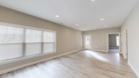 Located at 151 Hope Dr in Winchester, Virginia, this well-designed single-floor, one-bedroom, one-bathroom home offers a clean, modern aesthetic throughout. The open-concept main living area seamlessly integrates the living room, dining room, and kitchen, all finished with light-toned luxury vinyl plank flooring that enhances the bright, airy atmosphere. Recessed lighting illuminates the space, while large windows allow abundant natural light to fill the rooms.

The kitchen is a standout feature, equipped with stainless steel appliances including a refrigerator, range, microwave, and dishwasher. White shaker-style cabinetry pairs elegantly with granite countertops, and a central island provides additional prep and storage space. Pendant lighting above the island adds a refined touch.

The bedroom is comfortably sized, carpeted for warmth, and includes a dedicated closet. A glass-paneled entry door opens to an outdoor area, adding convenient exterior access. The bathroom features light wood-look flooring, a vanity with a white cabinet, and clean neutral finishes throughout.

Additional practical spaces include a pantry, dedicated laundry room, and a utility room. The neutral warm-beige wall palette and cohesive design choices give the entire home a polished, move-in-ready feel.