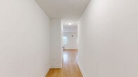 Unit 603 at 302 E Main St in Bound Brook, New Jersey, is a thoughtfully designed studio unit that makes efficient use of its single-floor layout. The open main living area features light-toned hardwood flooring throughout, crisp white walls, and clean-lined modern finishes that contribute to a bright, contemporary ambiance.

The kitchen is a standout feature, outfitted with slate-gray cabinetry spanning both upper and lower sections, white quartz countertops, and a full suite of stainless steel appliances including a refrigerator, range, microwave, and dishwasher. Track lighting above the kitchen area provides focused illumination, while a window with blinds allows natural light to enter the space.

The sleeping and living area is open and airy, with a louvered closet door and direct access to the bathroom, enhancing the functional flow of the unit. Clean white walls and recessed flush-mount lighting keep the space feeling bright and uncluttered.

The bathroom is finished with large-format white tile flooring, a gray vanity with a white countertop, a wall-mounted mirror with sconce lighting, and a glass-enclosed walk-in shower, lending a polished, contemporary feel to the space.