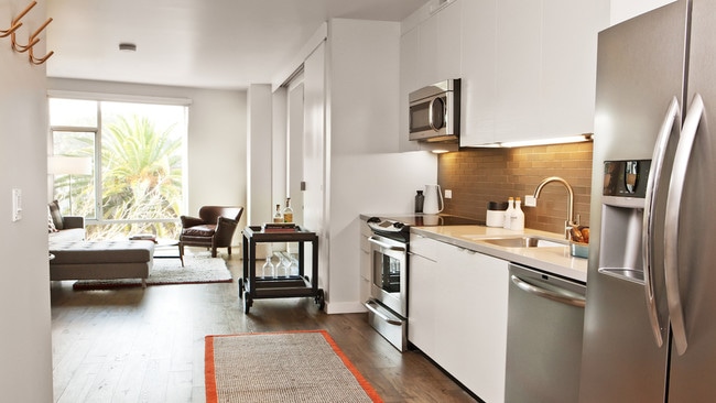 Sustainable hardwood flooring flows through the main living spaces, creating a warm, durable, and environmentally conscious backdrop for modern living. - 2175 Market