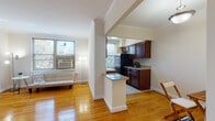 This single-floor residence in Alexandria, Virginia, offers a thoughtfully designed layout that balances comfort and functionality. Warm hardwood floors run throughout the main living areas and bedroom, complemented by classic crown molding that adds a refined architectural touch to each room.

The living area is bright and welcoming, benefiting from multiple windows that invite natural light and offer views of the surrounding neighborhood. A partial-wall peninsula separates the living space from the kitchen, creating an open yet defined layout. The kitchen is well-equipped, featuring rich dark wood cabinetry, granite-style countertops, black appliances including a gas range, dishwasher, microwave, and refrigerator, along with tile flooring and a window overlooking the exterior.

A dedicated dining area sits just off the entryway, providing a functional space for meals. The bedroom is generously proportioned, offering a ceiling fan, a large window with a radiator beneath it, and a closet with built-in shelving for ample storage. The bathroom features classic white subway tile, a vanity with dark wood cabinetry, and a shower-tub combination, maintaining a clean and timeless aesthetic throughout.