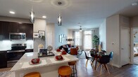 Located at 5415 N Foster Rd in San Antonio, Texas, this single-story residence offers a thoughtfully designed open-concept floor plan that seamlessly connects the kitchen, dining, and living areas into one cohesive living space. The kitchen is a standout feature, boasting rich dark cabinetry, stainless steel appliances, a white subway tile backsplash, granite countertops, and a peninsula island with bar seating illuminated by contemporary pendant lighting. Wood-style flooring flows throughout the main living area, enhancing the warm, modern aesthetic. The living room is bright and welcoming, benefiting from large windows that invite abundant natural light and provide outdoor views, complemented by a ceiling fan overhead. The bedroom is a serene retreat, featuring plush carpeting, large windows with elegant drapery, and an accent wall that adds depth and character. The bathrooms are finished with granite vanity countertops, dark cabinetry, white subway tile surrounds in the tub-shower combinations, and neutral tile flooring, creating a clean and polished look throughout. The overall ambiance of this residence is contemporary and comfortable, with a cohesive design palette that balances modern finishes with a warm, livable atmosphere.