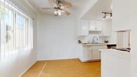 Located at 22555 Nadine Cir in Torrance, CA, this single-floor, 2-bedroom, 2-bathroom residence offers a well-organized and functional layout. The open-concept living and dining area is bright and airy, featuring warm hardwood-style flooring, a ceiling fan with light fixture, and a textured ceiling. Natural light fills the space through large windows, creating a welcoming atmosphere that flows seamlessly into the galley-style kitchen. The kitchen is outfitted with crisp white cabinetry, white countertops, stainless steel appliances including a range and microwave, a double-basin sink, and track lighting overhead — making it both practical and visually clean. The bedrooms are carpeted for comfort, each benefiting from ample natural light through large sliding or vertical-blind windows. The primary bedroom is generously sized and connects conveniently to a bathroom featuring a walk-in closet, a white vanity with mirror, and a tub/shower combination with glass doors. A second bathroom mirrors the clean, minimal aesthetic. Three closets throughout the unit provide excellent storage. A private balcony extends the living space outdoors. Hallways connect the rooms efficiently, completing this well-appointed Torrance residence.