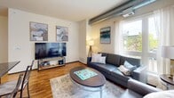 Located at 309 Oak St SE in Minneapolis, Minnesota, this two-bedroom, two-bathroom unit offers a well-designed single-level layout with a comfortable and functional floor plan. The living room serves as the heart of the home, featuring warm hardwood flooring, large corner windows that flood the space with natural light, and an industrial-modern aesthetic accented by exposed metallic ductwork running along the ceiling. The open, airy atmosphere makes the living area feel inviting and spacious.

The primary bedroom is generously sized, offering direct access to natural light through a large window with outdoor views, soft carpeting underfoot, and a notable dual-closet configuration with wire shelving for ample storage. The second bedroom is well-proportioned and similarly carpeted, also benefiting from natural light and enough space to comfortably accommodate both sleeping and workspace needs.

Both bathrooms are finished with tile flooring in neutral tones and include shower-tub combinations, offering clean and practical design. A hallway connects the rooms, contributing to a logical and efficient flow throughout the unit.

The overall ambiance blends urban industrial elements — most notably the exposed ductwork — with warm, neutral finishes to create a contemporary yet comfortable living environment in the heart of Minneapolis.