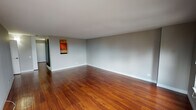 Situated in Chicago's vibrant Near North Side neighborhood at 100 W Chestnut St, this single-floor residence offers a well-appointed layout with a thoughtful blend of comfort and urban practicality. The main living area is generously proportioned, featuring warm-toned hardwood flooring that extends throughout, neutral gray walls, and clean white trim that lends the space a bright, contemporary feel. Multiple windows in the living area frame sweeping city views, flooding the room with natural light and providing an impressive connection to the Chicago skyline. The kitchen is efficiently designed with oak cabinetry offering ample storage, granite countertops, and stainless steel appliances including an electric range, making it both functional and attractive. The bedroom is a comfortable retreat, finished with plush carpeting, neutral tones, and a window that captures additional city views, creating a calm and restful atmosphere. The bathroom is cleanly appointed with white subway tile surrounding a full tub-shower combination, a vanity with a light stone countertop, and a large mirror that enhances the sense of space. Overall, the residence presents a cohesive, move-in-ready aesthetic rooted in classic urban design, ideally positioned to take advantage of everything Chicago's Near North Side has to offer.