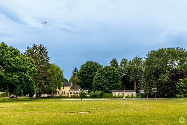 A small plane flies over scenic Cortland.