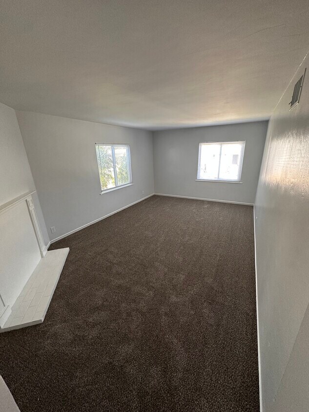 Spacious living room, recently updated with fresh paint and new carpet - 6333 MacArthur Blvd