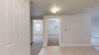 Located at 5950 Antoine Dr in Houston, TX, this three-bedroom, one-bathroom unit offers a practical and comfortable single-floor layout. The kitchen is a functional highlight, featuring rich cherry wood cabinetry, granite-style countertops, tile flooring, and stainless steel appliances including a dishwasher and refrigerator, along with a gas range. The open sightline from the kitchen into the living area creates a connected, easy-to-navigate floor plan. Each of the three bedrooms is finished with plush wall-to-wall carpeting, crown molding, and ceiling fans, lending a consistent and tidy aesthetic throughout. The bedrooms also benefit from natural light through window blinds, and the primary bedroom includes a double-door closet for added storage. The full bathroom is clean and bright, featuring tile flooring, a soaking tub, and a wood-vanity with a granite-top sink. A standout feature of this unit is the private balcony, which overlooks lush, mature magnolia trees and offers a refreshing outdoor retreat with open sky views. Crown molding is carried throughout the living spaces, adding a polished architectural detail to the overall design.