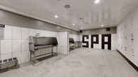 Located at 1912 S Jacaranda Street in Anaheim, CA 92805, Paw Spaw is a purpose-built, single-floor pet grooming facility spanning 400 square feet. The space is thoughtfully divided into two functional zones. The first is a open reception or play area featuring polished concrete floors, recessed lighting, and white walls adorned with a charming array of hand-drawn dog-face illustrations in black ink, creating a welcoming and pet-friendly atmosphere. A bold black-and-white geometric entry door adds a striking design accent to this area. The second zone serves as the professional grooming area, equipped with multiple stainless steel grooming tubs featuring integrated fixtures and hose attachments, stainless steel utility tables, and floor drains for efficient cleanup. The walls in this section are clad in large-format white tiles, ensuring a hygienic and easy-to-clean surface. Recessed ceiling lights illuminate both areas evenly, while the high-gloss ceiling finish enhances brightness throughout. The durable polished concrete flooring flows seamlessly across the entire space, providing a practical and modern aesthetic suited to the demands of a professional pet grooming operation.