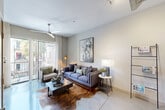 Located at 1 Hermann Park Court in Houston, TX, this thoughtfully designed one-bedroom, one-bathroom residence offers a comfortable and functional single-floor layout. The inviting living room features a ceiling fan, smooth concrete-style flooring, and a sliding glass door that opens to a private outdoor area, flooding the space with natural light and providing views of lush greenery. The kitchen is well-equipped with rich dark wood cabinetry, granite countertops, a tile backsplash, stainless steel appliances including a refrigerator and dishwasher, and track lighting overhead. A breakfast bar connects the kitchen to the living and dining area, enhancing the open flow of the space. The bedroom is a serene retreat with large windows dressed in sheer curtains and blinds that allow soft natural light, complemented by ample closet storage. The bathroom features granite countertops, wood cabinetry, and tile flooring for a clean, refined look. Additional highlights include a dedicated office, convenient in-unit laundry, multiple closets for storage, and hallways that connect the layout efficiently. The overall ambiance is modern and polished, making this residence a well-rounded urban home near the amenities of Hermann Park.