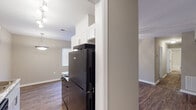 This single-floor residence in South Carolina offers a thoughtfully designed layout with consistent finishes throughout. Rich, dark hardwood-style flooring flows seamlessly across the living areas, bedrooms, and kitchen, creating a cohesive and inviting aesthetic.

The kitchen is a standout feature, showcasing crisp white shaker-style cabinetry with brushed nickel hardware, granite-look countertops, black appliances including a range and refrigerator, and a double stainless steel sink. Track lighting illuminates the galley-style workspace, which also connects to additional storage or utility space.

The open living and dining area is generously proportioned, filled with natural light from large windows fitted with blinds, and equipped with a ceiling fan with light fixture. The space flows comfortably for both everyday living and entertaining.

Multiple bedrooms offer well-sized, versatile spaces, each featuring the same hardwood-style flooring, neutral warm-toned walls, ceiling fans, and windows that allow ample natural light. The bathroom is clean and modern, featuring a tub/shower combination surrounded by classic white subway tile with dark grout detailing, offering a timeless and easy-to-maintain finish.

Throughout the home, neutral paint tones, white trim, and consistent flooring contribute to a bright, unified feel that is both functional and move-in ready.