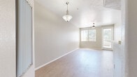 Located at 1891 N Litchfield Rd in Goodyear, AZ, this well-appointed 2-bedroom, 3-bathroom single-story home offers a clean, modern aesthetic throughout. The open living area features light wood-style flooring, a ceiling fan, and a pendant light fixture near the entry, creating a bright and welcoming atmosphere. Natural light filters in through windows with vertical blinds, and a door provides direct access to an outdoor patio area.

The kitchen is thoughtfully designed with white shaker-style cabinetry, light quartz countertops, a gray subway tile backsplash, and a full suite of stainless steel appliances including a refrigerator, range, over-the-range microwave, and dishwasher.

The primary bedroom is generously sized, featuring vaulted ceilings, a ceiling fan, a sliding-door closet, and a private en-suite bathroom with white cabinetry, a quartz vanity countertop, and a walk-in shower. The second bedroom also offers ample space, a ceiling fan, and a closet. Three bathrooms serve the home, each finished with wood-style flooring, white vanities, and clean, modern fixtures — one bath includes a step-in shower stall. The neutral warm-gray palette and consistent flooring throughout give the home a cohesive, move-in-ready feel.