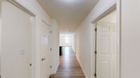 Located at 101 Clifton Park Cir in Wilmington, Delaware, this well-appointed 2-bedroom, 2-bathroom single-story home offers a thoughtfully designed layout with modern finishes throughout. Light-toned hardwood flooring flows seamlessly across the entire space, creating a clean and cohesive aesthetic.

The open kitchen and living area serves as the heart of the home. The kitchen is outfitted with rich dark-espresso cabinetry, granite countertops with sweeping natural veining, and a full suite of stainless steel appliances including a refrigerator, range, microwave, and dishwasher. A peninsula with an extended granite overhang connects the kitchen to the living area, ideal for casual dining or entertaining.

The spacious living room is bathed in natural light from multiple windows and features recessed lighting overhead. The primary bedroom is generously sized, offering ample space for furnishings, while the second bedroom also benefits from natural light and a neutral, versatile palette.

Both bathrooms are finished with clean white tile surrounds and dark vanity cabinetry topped with white counters. A dedicated laundry room houses a full-size washer and dryer. The hallway connects all rooms efficiently, with a closet providing additional storage. This home presents a bright, move-in-ready environment with contemporary finishes throughout.