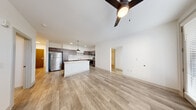 Located at 880 Maple Ave in Noblesville, Indiana, this 3-bedroom, 2-bathroom residence delivers a well-designed single-floor layout with contemporary finishes throughout. The open-concept living area and kitchen form the heart of the home, featuring light wood-tone luxury vinyl plank flooring, crisp white walls, and ceiling fans that enhance airflow and comfort. The kitchen is a standout feature, equipped with dark espresso shaker-style cabinetry, stainless steel appliances including a refrigerator, range, microwave, and dishwasher, a white subway tile backsplash, and a large center island with a clean white countertop. A pendant light fixture adds a modern industrial touch above the island. The living area benefits from natural light through large windows and a glass exterior door. The spacious primary bedroom offers plush carpeting and multiple windows that invite abundant natural light. The additional bedrooms also feature carpet flooring and windows with blinds. The bathrooms are finished with wood-look tile flooring, subway tile tub surrounds, and dark vanity cabinetry. A dedicated utility room provides added functional storage. The overall aesthetic is clean, modern, and move-in ready.