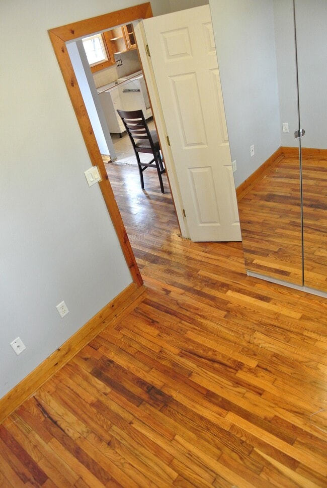 Lower level room with large windows, extra large wardrobe, ceiling fan, and large windows. - 1104 West Taylor Street