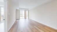 Located at 660 Sunningdale Rd E in London, Ontario, this well-designed one-bedroom, one-bathroom unit offers a bright and contemporary living experience across a single floor. Light-toned hardwood flooring flows seamlessly throughout, lending warmth and cohesion to the entire space.

The open-concept kitchen and living area serves as the heart of the unit. The kitchen is outfitted with crisp white upper cabinetry, natural wood-toned lower cabinets, light stone countertops, stainless steel appliances, and pendant lighting that adds a modern finishing touch. The living area is generously illuminated by floor-to-ceiling windows that frame views of the surrounding neighbourhood, with a sliding glass door providing direct access to a private balcony.

The bedroom is a comfortable and well-proportioned retreat, also featuring a sliding door to the balcony and large windows that invite an abundance of natural light. The clean, neutral palette of the walls complements the warm hardwood underfoot.

The bathroom is finished in a classic white scheme, featuring a full soaker tub with a shower curtain enclosure, an arched detail above the tub, a vanity with storage, and continued hardwood flooring. A hallway connects the rooms efficiently, completing this thoughtfully laid-out and light-filled home.