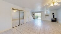 Located at 222 Summerhill Dr in Ithaca, NY, this two-story, three-bedroom, three-bathroom home offers a practical and comfortable layout spread across two floors. The ground floor features a bright, open kitchen equipped with white cabinetry, granite-style countertops, a coil-electric range, and a peninsula with a warm wood-toned base — all set atop clean tile flooring. A ceiling fan overhead adds to the airy feel of the kitchen and adjacent living area, which is bathed in natural light from sliding glass doors that open to the outdoors. The first floor also includes a closet with mirrored sliding doors, adding both storage and visual depth to the space. Upstairs, the three bedrooms are finished with warm hardwood floors and outfitted with ceiling fan fixtures. Each bedroom features mirrored sliding closet doors, and windows allow for natural light throughout. The three bathrooms maintain a clean, minimal aesthetic with white vanities, brushed nickel fixtures, wall-mounted mirrors, and white tub-shower enclosures. A hallway connects the upper-level rooms efficiently. Throughout the home, the consistent use of light tones, hardwood flooring, and tile creates a cohesive, clean atmosphere well-suited for everyday living in the Ithaca area.