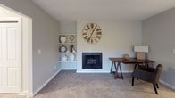 Located at 4129 Pine Creek Rd SW in Grandville, Michigan, this single-floor residence offers a thoughtfully designed layout with a clean, neutral aesthetic carried consistently throughout each room. The galley-style kitchen is well-equipped, featuring white shaker cabinetry, light marble-look countertops, stainless steel appliances including a gas range and dishwasher, a stainless sink, and light wood-look flooring that adds warmth to the space.

The dining area accommodates generous seating and is brightened by a window with outdoor views, complemented by a ceiling fan with lighting. Adjacent living areas include a carpeted room with a classic fireplace flanked by built-in shelving, providing both function and character.

Multiple bedrooms are finished with plush carpet, natural light from windows, and ample closet space, including a walk-in closet in the primary bedroom. Each bedroom maintains a calm, restful atmosphere with soft neutral tones. The bathroom features white cabinetry, a grey countertop vanity, framed mirrors, a medicine cabinet, and a shower-tub combination.

Overall, the space presents a cohesive, comfortable living environment with practical finishes and a consistently light, airy ambiance.