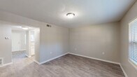 This one-bedroom, one-bathroom unit in Charlotte, NC offers a practical and well-organized single-floor layout. The living room features neutral-toned walls, wood-look laminate flooring, a textured ceiling, and a window that allows natural light to brighten the space. It connects seamlessly to the combined dining room and kitchen area, where a peninsula-style breakfast bar serves as a functional divider. The kitchen is equipped with white cabinetry, light granite-style countertops, a gas range with overhead ventilation, and a dishwasher, complemented by a dedicated pantry for additional storage. The bedroom is a comfortable size, featuring wood-look flooring, a window with blinds offering outdoor views, and direct access to a closet. The bathroom includes a full tub-shower combo with chrome fixtures, a toilet, and a vanity, finished with clean white surfaces and wood-look flooring. Throughout the unit, consistent laminate flooring, crisp white trim, and neutral wall tones create a cohesive and clean aesthetic. A hallway connects the main rooms efficiently, and three closets across the unit provide generous storage options. The layout is designed for functional everyday living.