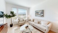 This 490 square foot apartment in San Jose offers a thoughtfully designed living space. The open-concept layout maximizes the available area, seamlessly blending the living room, kitchen, and dining area. The living room boasts large windows that flood the space with natural light and provide stunning city views, creating an airy and expansive feel.

The kitchen features light wood cabinetry, white appliances, and a clean backsplash, offering both functionality and style. The bedroom, measuring 120 square feet, is a serene retreat with a large window, plush carpeting, and ample closet space. The bathroom showcases a modern design with a wood vanity, large mirror, and a combination tub/shower.

Throughout the apartment, neutral tones and light wood flooring create a cohesive and contemporary aesthetic. Thoughtful touches like artwork and plants add personality to the space. The apartment's efficient layout and modern amenities make it an ideal urban dwelling, perfect for those seeking a stylish and low-maintenance lifestyle in the heart of San Jose.