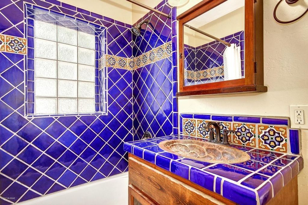 Lovely blue-tiled bathroom with shower/tub combo. - 2648 E Drachman St