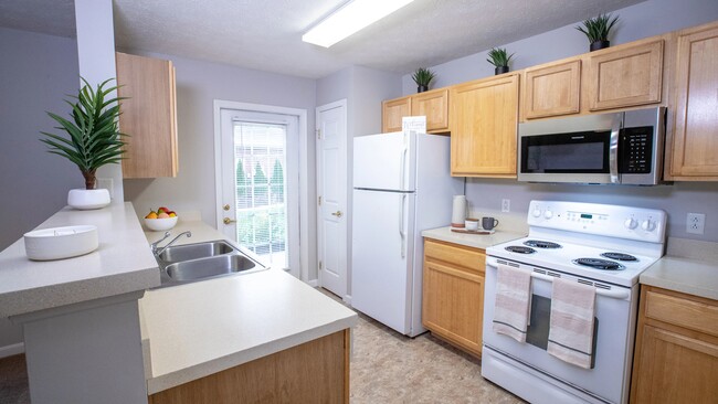 Traditional kitchens with abundant storage and a full appliance suite – including stainless-steel microwave and dishwasher. - The Reserve at Monroe Crossings