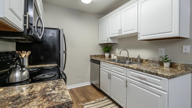 Embrace culinary creativity in our galley-style kitchens with ample cabinetry for optimal storage and organization. - Ridgemar Commons