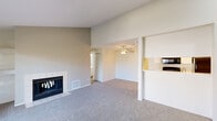 Located at 1021 Valley Bluff Dr in Perrysburg, Ohio, this 2-bedroom, 2-bathroom home offers a well-organized single-floor layout with notable architectural details throughout. The living room serves as the heart of the home, featuring vaulted ceilings that lend an airy, open feel, plush wall-to-wall carpeting, and a tile-surround fireplace with a built-in shelf above — a natural focal point for the room. A sliding glass door floods the space with natural light and opens directly onto a private deck, providing pleasant outdoor views. The kitchen is accessible via a pass-through opening from the living area, offering a practical and connected layout. Both bedrooms continue the vaulted ceiling design and are carpeted, each featuring a large window that allows ample natural light and outdoor views. The primary bedroom includes dedicated closet space. The two bathrooms are clean and functional: one features a full tub/shower combination with chrome fixtures and wood-look flooring, while the second offers a vanity with a wide mirror and matching wood-look flooring. Additional spaces include a hallway, two closets, a laundry area, and a staircase, rounding out this well-appointed and efficiently designed home.