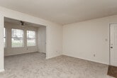 Located at 4150 Arkwright Rd in Macon, Georgia, this single-floor residence offers a practical and comfortable layout across a well-organized floor plan. The living and dining areas are finished with neutral-toned carpet and cream-colored walls, creating a clean, versatile backdrop. An open passageway connects the main living space to a bright front room with multiple windows, allowing natural light to flow throughout.

The kitchen is equipped with light wood cabinetry, a peninsula countertop that opens to the adjacent living area, white appliances including an electric range and refrigerator, a dishwasher, and a double sink — all set on durable wood-look flooring. A range hood and ample upper and lower cabinet storage add functional efficiency to the space.

The bedrooms are carpeted and generously sized, each featuring ceiling fans and windows with blinds that offer views of surrounding greenery. The textured ceilings throughout the home add a classic finish consistent with the overall design.

The bathrooms are outfitted with wood-look plank flooring, a tub-shower combination, toilet, and a single-sink vanity topped with a marble-patterned countertop and framed by a wall mirror. The entry foyer transitions smoothly from wood-look flooring to carpet, anchoring the home's cohesive interior design.