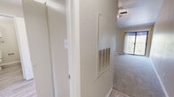 Located at 611 Lead Ave SW in Albuquerque, NM, this well-appointed 1-bedroom, 1-bathroom single-floor residence offers a thoughtful layout across a comfortable footprint. The living room immediately impresses with its dramatic vaulted ceilings, a ceiling fan, and a sliding glass door that invites abundant natural light and outdoor views. Light-toned carpet flows throughout the living and bedroom areas, complementing the neutral wall palette.

The kitchen is outfitted with crisp white cabinetry, granite-style countertops, stainless steel appliances including a gas range and refrigerator, and wood-look vinyl flooring — providing both style and functionality. Hallways connect the space efficiently, leading to the generously sized bedroom, which features a ceiling fan, a broad window with natural light, and direct access to a large walk-in closet equipped with dual hanging rods and shelving.

The bathroom offers white cabinetry, a vanity with countertop storage, and matching wood-look flooring consistent with the rest of the unit. A dedicated in-unit laundry room houses a full-size washer and dryer, adding everyday convenience. Overall, the space presents a clean, modern aesthetic with practical amenities throughout.