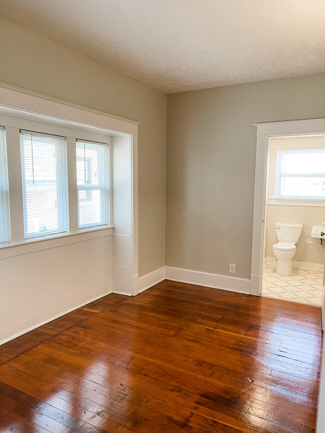 Bedroom with unique window bay. - 6 Nineteen Apartments