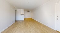 Located at 2104 S Lewis St in Anaheim, CA, this 1-bedroom, 1-bathroom unit offers a well-designed, single-floor layout that maximizes every square foot. Light wood-style flooring runs throughout, creating a bright and cohesive aesthetic across all rooms.

The open-concept living and kitchen area forms the heart of the unit. The kitchen is outfitted with white shaker cabinetry, granite countertops, a deep stainless steel sink with a modern pull-down faucet, and a full suite of stainless steel appliances including a gas range, refrigerator, and dishwasher. A peninsula counter separates the kitchen from the living area, which features a ceiling fan and flows naturally toward a sliding glass door that opens to a private balcony, inviting ample natural light.

The spacious primary bedroom is well-proportioned, offering mirrored sliding closet doors, a large window with vertical blinds, and the same warm flooring found throughout the unit. The bathroom includes a clean, all-white tub-shower combination with chrome fixtures. A dedicated in-unit laundry area with washer and dryer hookups adds a practical convenience. This thoughtfully laid-out unit offers comfortable, modern living in Anaheim.
