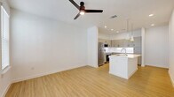 Located in Boerne, TX, this well-designed one-bedroom, one-bathroom unit offers a thoughtfully planned single-level layout finished with modern details throughout. Light wood-look flooring runs through the main living areas, creating a clean, cohesive aesthetic. The open-concept living room and kitchen are anchored by a ceiling fan with integrated lighting, recessed lights, and large windows that invite natural light into the space.

The kitchen is a standout feature, equipped with stainless steel appliances including a range, microwave, dishwasher, and refrigerator. Gray shaker-style cabinetry with matte black hardware pairs with white quartz countertops and a classic white subway tile backsplash. A peninsula with an undermount sink provides additional prep space and casual seating potential, while stylish pendant lights add a modern touch.

The bedroom is carpeted for comfort, features a ceiling fan, a natural-light window with blinds, and connects to a spacious walk-in closet with built-in shelving. The full bathroom offers a long vanity with white countertops, an undermount sink, a large mirror, and a walk-in shower. A dedicated laundry area houses a front-load washer. The unit also includes a utility room, hallway, and access to a private patio.