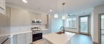 This contemporary 620 square foot apartment in Denver offers a harmonious blend of style and functionality. The heart of the home is the open-concept kitchen, showcasing a striking island with a built-in sink, complemented by pendant lighting. The kitchen boasts light-colored cabinetry, stainless steel appliances, and ample counter space, perfect for culinary enthusiasts.

The spacious bedroom, measuring 130 square feet, features plush carpeting and a large window that floods the space with natural light. A ceiling fan adds both style and comfort. The bathroom is a model of modern design, with a sleek vanity, large mirror, and a glass-enclosed shower.

Throughout the apartment, you'll find a mix of warm wood-look flooring and soft carpeting, creating a cozy yet sophisticated atmosphere. The layout maximizes space efficiency, with a well-organized closet featuring multiple shelving levels.

High ceilings and recessed lighting contribute to the apartment's airy feel, while the neutral color palette provides a canvas for personal style. This thoughtfully designed space offers urban living at its finest, combining comfort, style, and practicality in one attractive package.