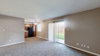 Located at 59 Port Ocall Dr in Indianapolis, Indiana, this single-floor, 3-bedroom, 1-bathroom home offers a practical and comfortable layout. The combined kitchen and living area serves as the heart of the home. The kitchen is equipped with warm-toned wood cabinetry, light granite-style countertops, black appliances including a refrigerator, electric range, and dishwasher, and wood-look flooring. A ceiling fan provides additional comfort in this space, and a window allows natural light to fill the room. The living room features neutral carpet, warm beige walls, and a sliding glass door that opens to a view of the backyard, bringing in ample natural light. A front entry closet provides convenient storage near the main entrance. Each of the three bedrooms is carpeted and finished with neutral tones, offering a calm and versatile space. The bedrooms each include their own closet with hanging rods. The primary bedroom is a comfortable size, while the secondary bedrooms are well-proportioned. The single bathroom features wood-look flooring, a full tub and shower combination, a toilet, and a wood-toned vanity, all finished in clean white tones. Throughout the home, a consistent neutral color palette creates a cohesive and move-in ready atmosphere.