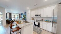 Located at 2652 S Main St NW in Kennesaw, GA, this well-appointed one-bedroom, one-bathroom residence offers a thoughtfully designed open-concept layout that maximizes its comfortable footprint. The kitchen is a standout, featuring crisp white shaker cabinetry, stainless steel appliances including a French door refrigerator and range, a subway tile backsplash, and a generous granite-topped island with bar seating — ideal for both cooking and casual dining. Light wood-tone flooring flows seamlessly from the kitchen into the living area, which is anchored by a dramatic navy blue accent wall, arched floor-to-ceiling windows, and abundant natural light that creates a vibrant yet inviting atmosphere. The bedroom continues the airy feel with large arched windows, a soft blue accent wall, plush carpeting, and generous natural light from multiple exposures. The full bathroom mirrors the home's refined aesthetic with granite countertops, an undermount sink, and a tiled tub-shower combination. A dedicated laundry area with a stacked full-size washer and dryer adds everyday convenience. Recessed lighting throughout and clean white walls lend the entire space a modern, polished character.