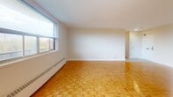 Located at 32 Clayland Dr in Toronto's M3A neighbourhood, this 2-bedroom, 1-bathroom unit offers a well-organized layout across a single floor. Warm parquet flooring runs throughout the living spaces and bedrooms, adding a classic character to the interior.

The combined kitchen and living room area forms the heart of the unit. The living room is generously proportioned, bathed in natural light from large windows that offer views of the surrounding greenery. Baseboard heating runs along the walls, ensuring comfort throughout the seasons. The kitchen is functionally laid out with white cabinetry, a tiled floor, and includes a stove, providing direct sightlines to the balcony access — a convenient feature for everyday living.

The two bedrooms are bright and well-sized, each featuring parquet floors, neutral walls, and windows that let in natural light. The primary bedroom offers a comfortable footprint with a built-in closet. The second bedroom is similarly appointed, providing flexibility for use as a guest room or home office.

The bathroom is clean and practical, featuring a full-sized bathtub with a tiled surround and chrome fixtures. A private balcony completes the unit, offering an outdoor retreat with views of the neighbourhood.