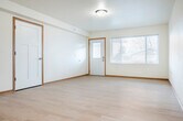 Located at 695 E Blackhawk Ave in Prairie du Chien, Wisconsin, this single-story, 3-bedroom, 1-bathroom home offers a clean, modern interior designed for comfortable everyday living. Light wood flooring flows throughout the space, complemented by crisp white walls and warm wood-tone trim, creating a bright and welcoming atmosphere.

The open living area is generously sized, featuring a wall-mounted mini-split unit for efficient climate control and direct sightlines to the kitchen. The kitchen is well-appointed with light maple cabinetry, stone-look countertops, a stainless steel GE range with range hood, and ample counter and storage space.

The primary bedroom is spacious and includes a large walk-in closet with wire shelving. Two additional bedrooms provide flexible space, each with light flooring and neutral walls. The full bathroom is thoughtfully designed with accessibility in mind, featuring stainless steel grab bars near the toilet and shower, a wood-vanity with a wide countertop, and a large mirror.

A dedicated laundry room houses a modern GE front-load washer/dryer combo. Utility rooms provide additional functional storage. The attached garage features drywall finishing, a garage door opener, and a concrete floor, offering secure parking and extra storage. Natural light enters through windows in the living and bedroom areas, enhancing the home's bright, airy feel.