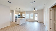 Located at 22344 Montgomery Pines Rd in Porter, TX, this single-story home offers a thoughtfully designed layout with three bedrooms, three bathrooms, and three closets. Light-toned luxury vinyl plank flooring flows consistently throughout the home, creating a clean, cohesive aesthetic complemented by crisp white trim and neutral gray walls.

The kitchen serves as a central highlight, featuring a granite-topped island with pendant lighting overhead, gray shaker-style cabinetry, a white subway tile backsplash, and a full suite of stainless steel appliances including a refrigerator, range, microwave, and dishwasher. Natural light pours in through multiple windows fitted with blinds.

Each bedroom is comfortably sized, with the primary bedroom offering a well-proportioned layout. Bedrooms include ceiling fans and access to dedicated closets. The bathrooms are finished with granite countertops, undermount sinks, gray cabinetry with modern hardware, and light wood-look flooring. One bathroom features a tiled tub-shower combination, while the primary bath includes an elongated vanity with ample storage.

Throughout the home, the design emphasizes clean lines, modern fixtures, and a bright, airy atmosphere that makes the space feel welcoming and move-in ready.