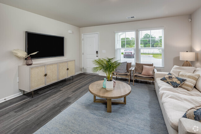 Living room towards front entry from dining room. - Coastal Wind