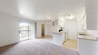 Located at 5300 W Gulf Bank Rd in Houston, Texas, this single-floor home offers three bedrooms, one bathroom, a kitchen, and a closet, all within a compact and efficiently arranged floor plan. The galley-style kitchen is well-equipped with ample white cabinetry lining both walls, generous counter space, a double stainless steel sink, a coil-top range, and a dishwasher. Light tile flooring and bright overhead lighting keep the kitchen feeling clean and functional. The bedrooms feature neutral carpet flooring and ceiling fans with light fixtures, creating a comfortable and practical environment. The primary bedroom is notably spacious and includes two closets, providing excellent storage capacity. A carpeted hallway connects the living areas and bedrooms, with a glimpse of natural light visible at the end, hinting at an outdoor view. The full bathroom is finished with tile flooring, a vanity with under-sink cabinetry, and a white tiled tub and shower combination. Throughout the home, white walls and neutral tones create a clean, move-in-ready aesthetic. The layout, as visible in the dollhouse view, is straightforward and well-organized, making efficient use of the available space.