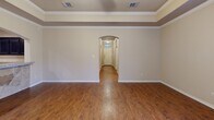 Located at 514 Deacon Drive W in College Station, TX, this single-story home offers four bedrooms and six bathrooms across a well-designed floor plan. The combined living and dining area serves as the heart of the home, featuring rich hardwood flooring, crown molding, a tray ceiling with ceiling fan, and multiple windows that fill the space with natural light. A glass-paneled back door provides direct access to the outdoor area. The kitchen is outfitted with dark espresso cabinetry, granite countertops, and black appliances, including a refrigerator, built-in microwave, and electric range, all complemented by tile flooring. The bedrooms are carpeted for comfort, each equipped with a ceiling fan and window for natural ventilation and light. The primary bedroom connects directly to its own en-suite bathroom featuring dark vanity cabinetry and granite countertops. The six bathrooms are consistently finished with tub-shower combinations and granite-topped vanities. A dedicated laundry room houses a full-size washer and dryer. Five closets provide ample storage throughout, and an attached garage adds additional convenience. Crown molding and consistent warm-toned walls tie the home's interior together cohesively.
