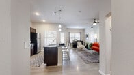 Located at 7210 Potranco Road in San Antonio, TX, this single-story, one-bedroom, one-bathroom residence offers a thoughtfully designed open-concept layout. The combined kitchen, dining, and living area forms the heart of the home, finished with light wood-style flooring throughout. The kitchen is outfitted with dark espresso cabinetry, granite countertops, stainless steel appliances — including a refrigerator, range, and microwave — and a central island with seating, illuminated by modern pendant lighting. The adjacent dining area accommodates a full dining table and opens directly to a private patio through a sliding glass door, bringing in natural light and outdoor views. The living room is spacious and bright, benefiting from multiple windows and a ceiling fan. The bedroom offers a comfortable retreat with plush carpet flooring, a ceiling fan, and a window with natural light. Three closets provide generous storage, highlighted by a walk-in closet with wire shelving. The full bathroom features dark cabinetry with a granite vanity top, wood-style tile flooring, and a full tub/shower combination. A dedicated in-unit laundry room houses a full-size washer and dryer, completing this functional and modern residence.