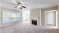 Located at 309 Hammocks View in Savannah, Georgia, this well-appointed 3-bedroom, 2-bathroom single-story home offers a comfortable and functional layout. The living room serves as the heart of the home, featuring a tile-surround fireplace with a classic white mantel, crown molding, a ceiling fan, and abundant natural light from large windows with blinds. It flows seamlessly into the dining area, which is distinguished by warm hardwood flooring, crown molding, a pendant light fixture, and a glass-panel door providing outdoor access. The kitchen is equipped with white cabinetry, granite-style countertops, stainless steel appliances including a gas range and dishwasher, and hardwood floors. The generously sized primary bedroom includes plush carpeting, a ceiling fan, and natural light, and connects to an en suite bathroom featuring a dual-sink vanity with granite-style countertops, white cabinetry, and a walk-in closet. The second bathroom mirrors this refined style with a single-sink vanity and matching finishes. The two additional bedrooms offer comfortable proportions, carpet flooring, ceiling fans, and windows with outdoor views, making them ideal for guests or a home office.