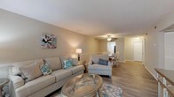 Located at 1503 E Park Ave in Valdosta, Georgia, this single-floor residence offers a well-designed layout that balances comfort and functionality. The open-concept living and dining area forms the heart of the home, with hardwood-style flooring running throughout and neutral warm-toned walls that create a welcoming atmosphere. Large sliding glass doors fitted with vertical blinds allow an abundance of natural light to fill the living space while providing outdoor views of surrounding greenery. A ceiling fan overhead adds to the room's practicality and charm.

The kitchen features granite-style countertops, gray shaker cabinetry with brushed nickel hardware, a stainless steel sink, and black appliances — delivering a clean, modern aesthetic. The dining area flows seamlessly from the living room, making the space ideal for entertaining.

The bedrooms are generously proportioned, each with hardwood-style flooring, neutral gray walls, and windows that invite natural light. The primary bedroom includes access to a private hallway and closet space. Two full bathrooms serve the home, each equipped with a tub-shower combination. The overall design is cohesive, with a consistent neutral palette and modern finishes that give the entire residence a fresh, move-in-ready appeal.
