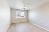 Located at 9910 W Montebello Ave in Phoenix, AZ, this single-story, 2-bedroom, 2-bathroom home offers a clean, modern aesthetic throughout. Light-toned luxury vinyl plank flooring flows through the main living areas, creating a cohesive and bright atmosphere.

The kitchen is a standout feature, showcasing white shaker-style cabinetry, dark granite countertops, and a full suite of stainless steel appliances including a range, microwave, and refrigerator. Recessed lighting illuminates the space, which opens toward the main living area for a connected, functional layout.

Both bedrooms are carpeted for comfort and include ceiling fans, closets, and windows that invite natural light. The primary bedroom offers a dedicated closet with a hanging rod, while both rooms maintain a clean, neutral palette. Each bedroom is served by its own bathroom, both featuring tub-shower combinations with white tile surrounds, chrome fixtures, and hard-surface flooring.

A connecting hallway links the private and shared areas of the home efficiently. Throughout the space, neutral wall tones, white trim, and consistent finishes contribute to a cohesive and move-in-ready environment. The layout makes practical use of every square foot, offering comfortable, functional living in a straightforward single-floor design.