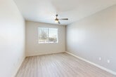 Located at 9910 W Montebello Ave in Phoenix, AZ, this single-story, 2-bedroom, 2-bathroom home offers a clean, modern aesthetic throughout. Light-toned luxury vinyl plank flooring flows through the main living areas, creating a cohesive and bright atmosphere.

The kitchen is a standout feature, showcasing white shaker-style cabinetry, dark granite countertops, and a full suite of stainless steel appliances including a range, microwave, and refrigerator. Recessed lighting illuminates the space, which opens toward the main living area for a connected, functional layout.

Both bedrooms are carpeted for comfort and include ceiling fans, closets, and windows that invite natural light. The primary bedroom offers a dedicated closet with a hanging rod, while both rooms maintain a clean, neutral palette. Each bedroom is served by its own bathroom, both featuring tub-shower combinations with white tile surrounds, chrome fixtures, and hard-surface flooring.

A connecting hallway links the private and shared areas of the home efficiently. Throughout the space, neutral wall tones, white trim, and consistent finishes contribute to a cohesive and move-in-ready environment. The layout makes practical use of every square foot, offering comfortable, functional living in a straightforward single-floor design.