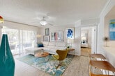 Located at 2037 Polo Gardens Dr in Wellington, FL, this well-appointed 2-bedroom, 3-bathroom single-floor residence offers a thoughtfully designed open-concept layout. The bright and airy living room features light wood-style flooring, a ceiling fan, textured ceilings, and large sliding glass doors that open to a private outdoor patio, flooding the space with natural light. The kitchen is equipped with stainless steel appliances, crisp white cabinetry, a light countertop breakfast bar, and seating for casual dining — ideal for both everyday meals and entertaining. A hallway connects the living areas to the bedrooms, maintaining a smooth and functional flow throughout. The generously sized primary bedroom features plush carpet, a ceiling fan, and windows with outdoor views, complemented by closet storage. Additional bedrooms also offer comfortable proportions with built-in closets. The three bathrooms include a combination tub-shower with clean white tile finishes, a standalone walk-in shower, and vanities with white cabinetry. Throughout the home, the consistent use of light tones, wood-style flooring, and natural light creates a cohesive, welcoming atmosphere suited for comfortable living in South Florida.