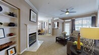 This single-story residence is thoughtfully designed with an open, flowing layout that connects the main living areas seamlessly. The living room serves as the heart of the home, anchored by a classic white-mantled fireplace and crowned with elegant crown molding. A ceiling fan provides comfort overhead, while large windows dressed with blinds and drapes invite generous natural light and frame views of the outdoors. A glass-paneled front door further enhances the bright, welcoming atmosphere.

Adjacent to the living room, the dining area accommodates intimate gatherings beneath a stylish pendant light, with additional windows contributing to the room's airy feel. The kitchen is outfitted with rich, dark wood cabinetry, white countertops, a double stainless steel sink, and tile flooring — offering a functional and attractive workspace.

The bedroom is a comfortable retreat, featuring plush carpeting, crown molding, a ceiling fan, and a walk-in closet with organized shelving. Natural light filters through a window with blinds and drapes, creating a restful ambiance.

The bathroom maintains a clean, minimalist aesthetic with white cabinetry, a single vanity sink, and a well-organized layout. Throughout the residence, warm neutral tones, plush carpeting in living spaces, and tile flooring in utility areas combine to create a cohesive and inviting environment.