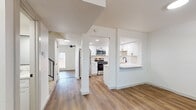 Located in Germantown, TN, this two-story home offers four bedrooms and four bathrooms spread across two well-proportioned floors. The main level features an open-concept layout where the kitchen flows seamlessly into the living area, all unified by warm wood-look luxury vinyl plank flooring. The kitchen is a standout, showcasing crisp white shaker cabinets with matte black hardware, quartz countertops, a herringbone tile backsplash, stainless steel appliances, and a peninsula that provides additional prep and serving space. Recessed lighting brightens the entire main level. Upstairs, the bedrooms offer a mix of flooring options, with carpeted rooms providing comfort alongside continued LVP in other areas. The primary bedroom includes a dedicated closet and convenient access to in-unit stacked laundry. The bathrooms are finished to a high standard, featuring quartz vanity tops, matte black fixtures, and marble-style tile surrounds in the tub and shower areas. One full bath includes a double-sink vanity with framed mirrors. Additional bedrooms receive ample natural light through large windows with outdoor views of the surrounding greenery. Ceiling fans are present in several rooms. The home's clean, neutral palette and modern finishes create a bright, cohesive ambiance throughout.